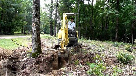 how to knock down pine trees with mini excavator|mini tree removal.